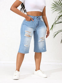 Lichtblauwe onregelmatig gescheurde mid-rise denim jeans